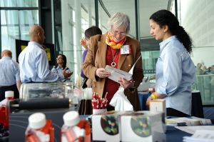 Photograph of people in discussion at a trade exhibition at Wembley Stadium